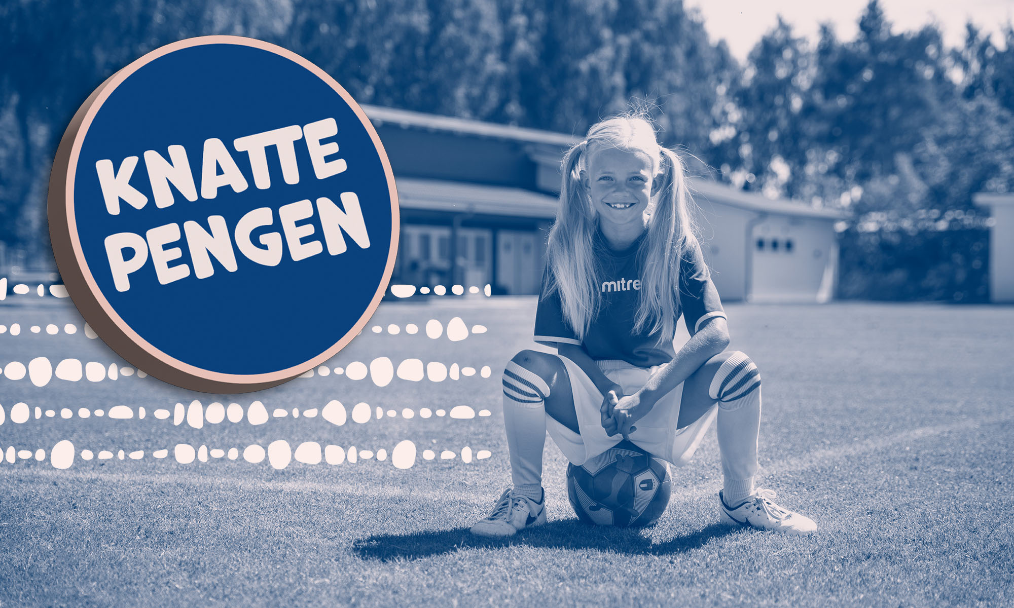 Glad fotbollstjej sitter på en boll på fotbollsplanen